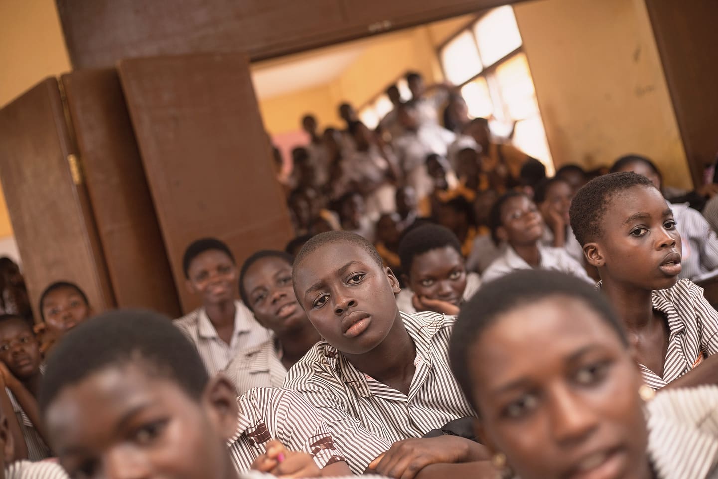 Salle de cours pleine de jeunes élèves attentifs